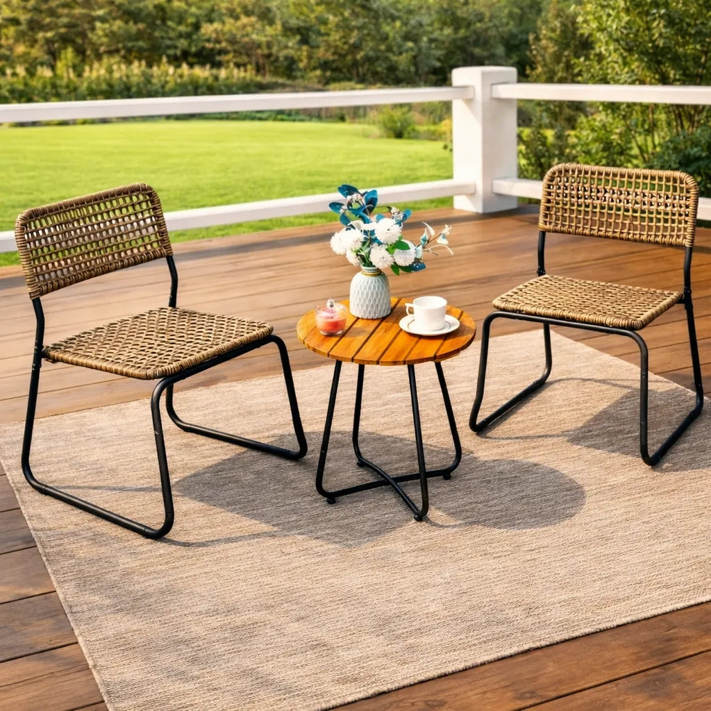 Outdoor furniture set with two wicker chairs and a small table on a wooden deck.