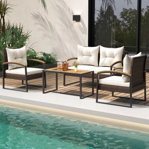 Outdoor patio furniture set with white cushions by a pool