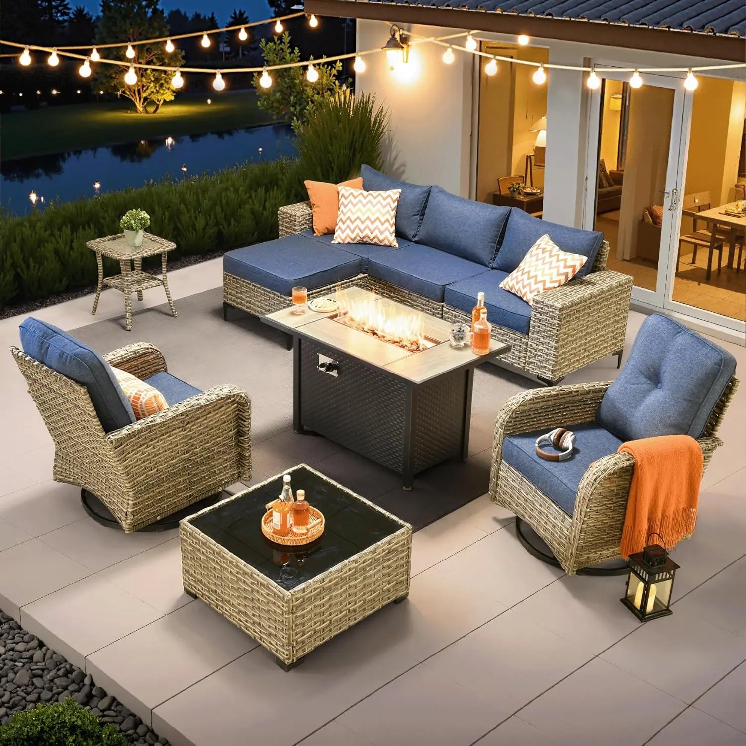 Outdoor patio set with fire pit table, chairs, and tables on a patio area.