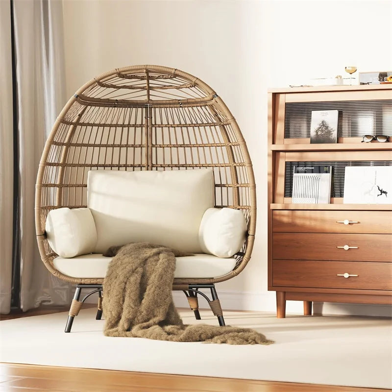 Wicker egg-shaped chair with cushions in a room with wooden furniture.